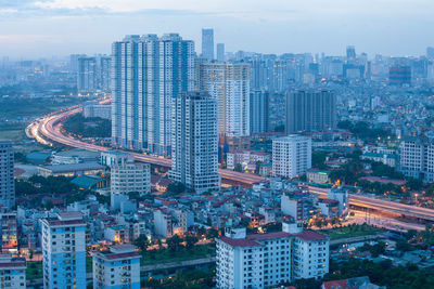 High angle view of modern buildings in city against sky