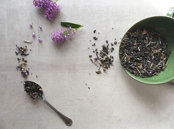 High angle view of flowers ande tea powder on table