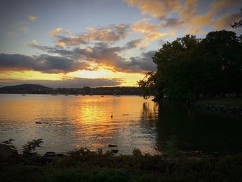 Scenic view of calm lake at sunset