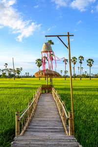 Traditional windmill on field against sky viewpoint dong tan sam khok , pathum thani, thailand