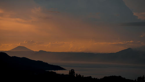 Scenic view of silhouette mountains against sky during sunset