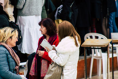People in traditional clothing standing in winter