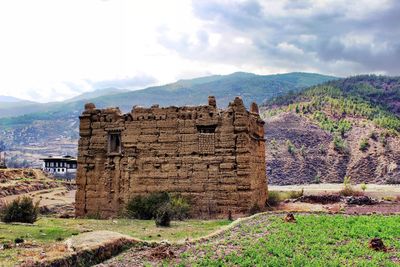 Old ruin on mountain against sky