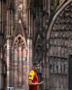 Full length of man standing in temple against building