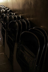 High angle view of chairs with desk arranged by wall