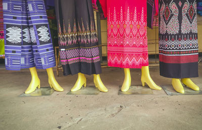 Low section of textile displayed on mannequins for sale at market