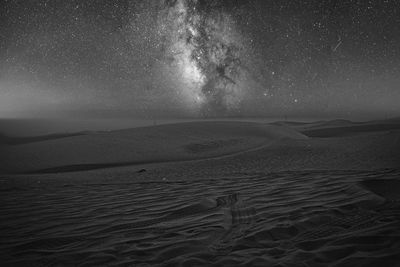 Scenic view of the desert against a starry sky at night