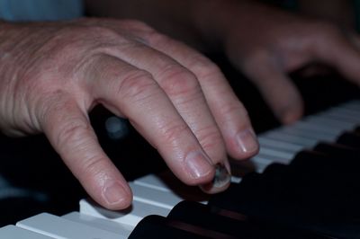 Close-up of person playing piano