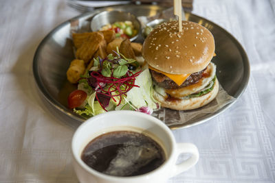 Close-up of burger with drink on table