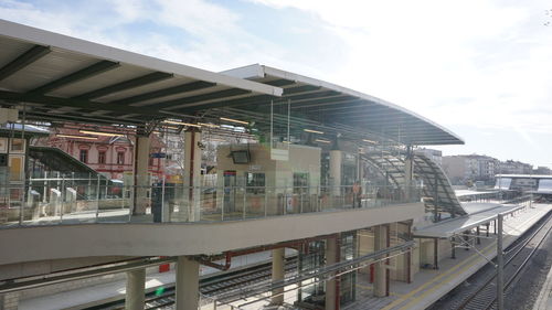 Train at railroad station against sky