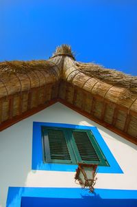 Low angle view of built structure against clear blue sky