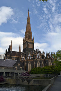 View of temple building against cloudy sky