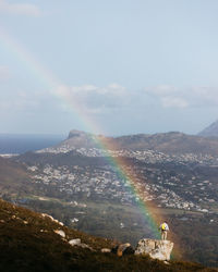 Up chapman's peak, clouds swarmed together, forming a thick mist. a beautiful rainbow appeared.