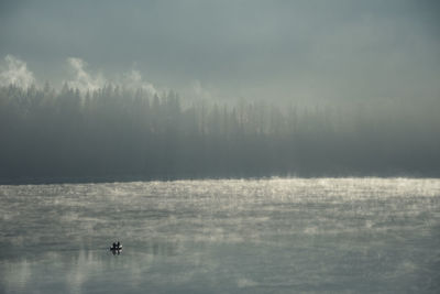 Boat and morning fog at sylvensteinsee, bad tolz, bavaria, germany