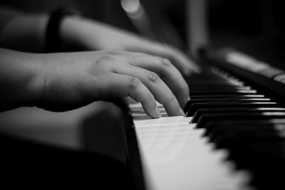 Close-up of hands playing piano