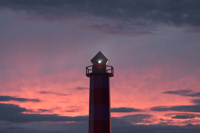 Marine navigational beacon in action. beautiful sunset sky in the background. shipping topics