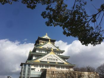 Low angle view of temple against cloudy sky