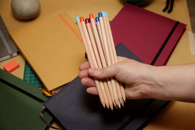 High angle view of woman reading book on table