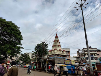 People on street in city against sky