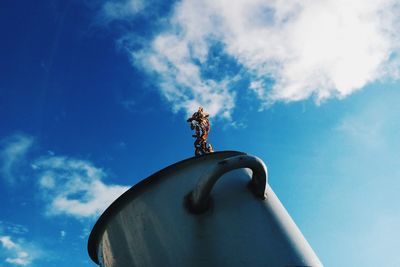 Low angle view of statue against blue sky