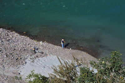 High angle view of man fishing at river