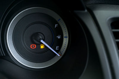 Close-up of fuel gauge on dashboard in car