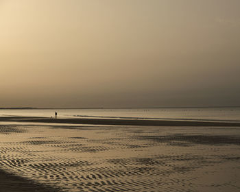 Scenic view of beach against sky during sunset