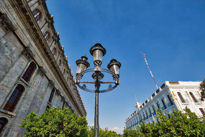 Low angle view of street light against building