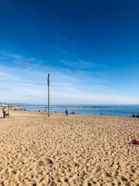 Scenic view of beach against blue sky