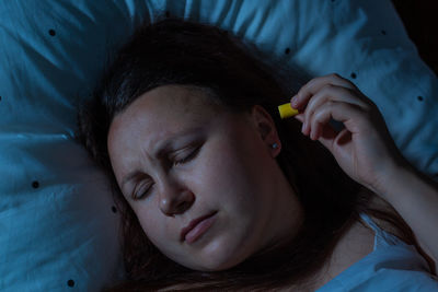 Close-up portrait of a woman sleeping on bed