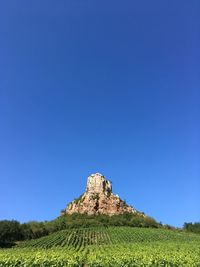Scenic view of land against clear blue sky ... roche de solutré