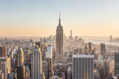 Aerial view of buildings in city against sky