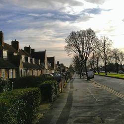 Empty road with buildings in background