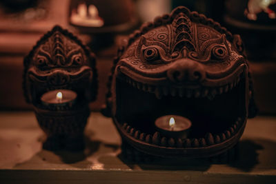 Close-up of illuminated candles on table