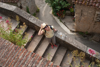 High angle view of woman standing on steps against houses