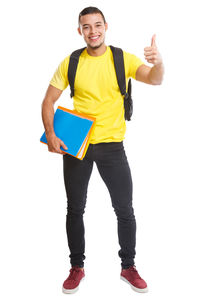 Portrait of young man standing against white background