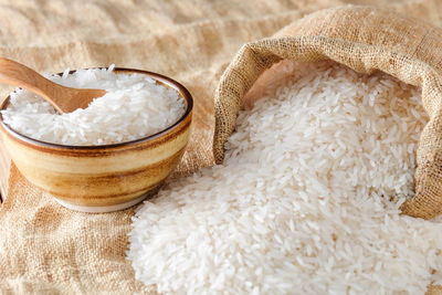 Close-up of bowl and sack with rice