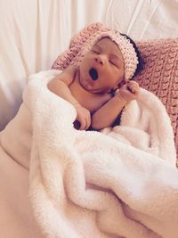 Cute baby girl yawning at home