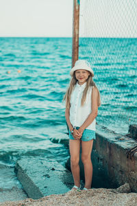 Portrait of woman standing in sea