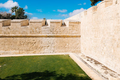 Wall against sky on sunny day