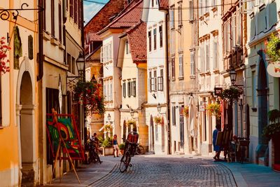 People walking on street amidst buildings in town