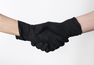 Close-up of hands over white background