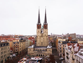 Buildings in city against clear sky