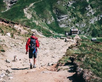 Rear view of people walking on mountain