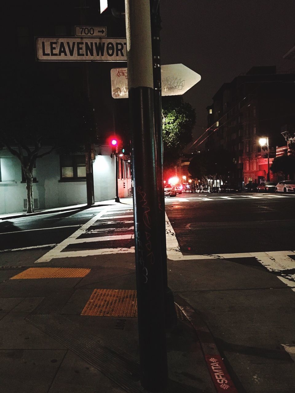 ROAD SIGN ON STREET AT NIGHT