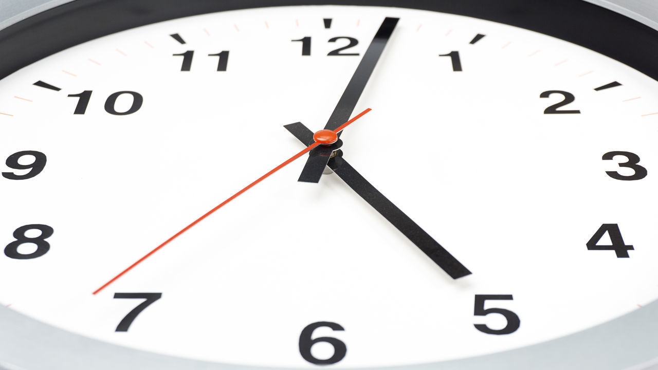 LOW ANGLE VIEW OF CLOCK ON WHITE BACKGROUND