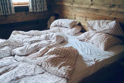 High angle view of messy bed