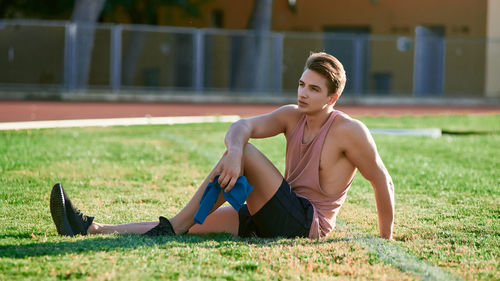 Full length of woman sitting on grass