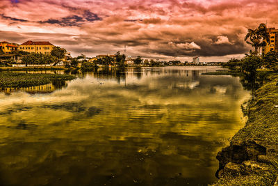 Scenic view of lake against sky at sunset