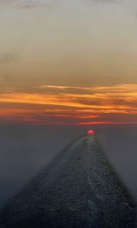 Scenic view of road against sky during sunset